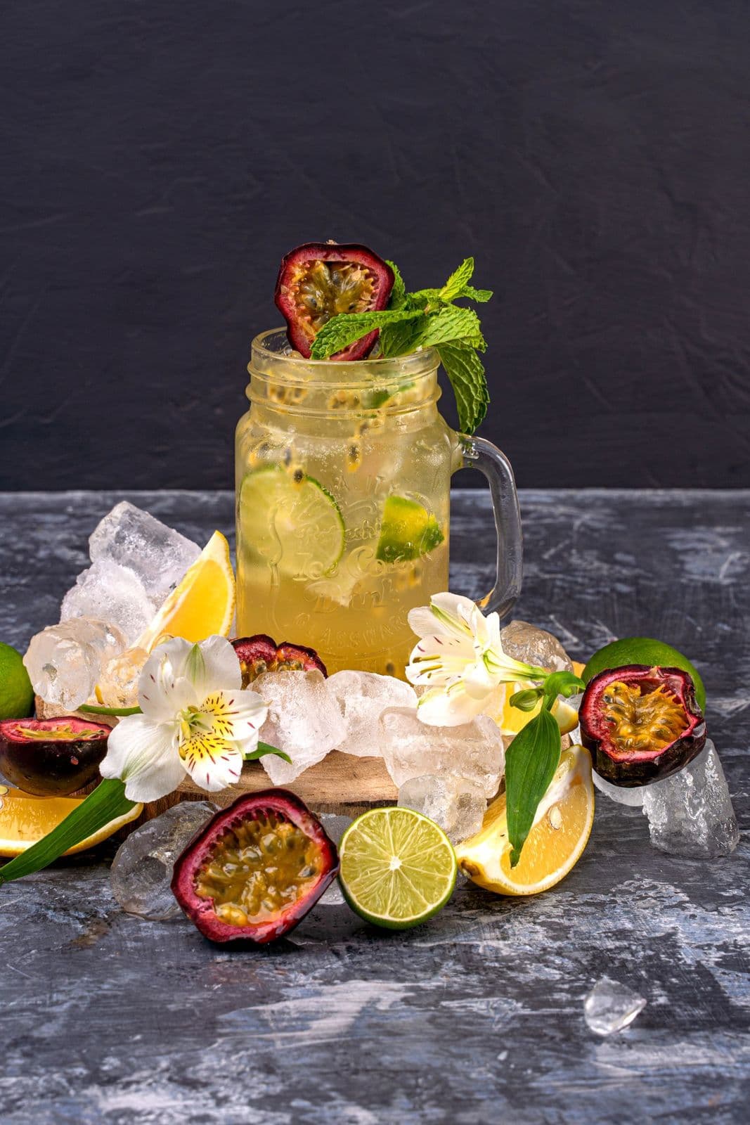 A glass of fizzy tropical passion fruit drink with ice and a garnish